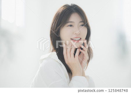 Young woman relaxing in the living room Young woman relaxing in the living room 125848748