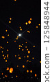 Lanterns and the moon dancing in the night sky 125848944