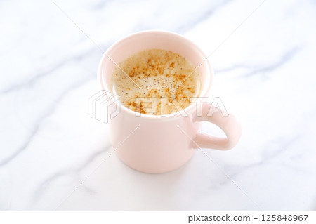 Image of a person relaxing while drinking a cafe latte, a mixture of espresso and milk Image of a person relaxing while drinking a cafe latte, a mixture of espresso and milk 125848967