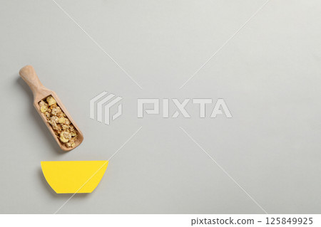 Muesli in a wooden scoop on a gray background 125849925
