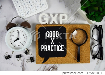 GXP - Good x Practice acronym with calculator, alarm clock and magnifying glass, Business and Financial concept background GXP - Good x Practice acronym with calculator, alarm clock and magnifying glass, Business and Financial concept background 125850011