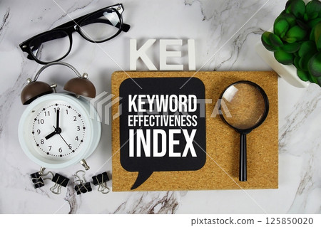 KEI - Keyword Effectiveness Index acronym with alarm clock and magnifying glass, data management concept background 125850020