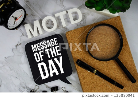 MOTD - Message Of The Day acronym with alarm clock and magnifying glass, business concept background MOTD - Message Of The Day acronym with alarm clock and magnifying glass, business concept background 125850041