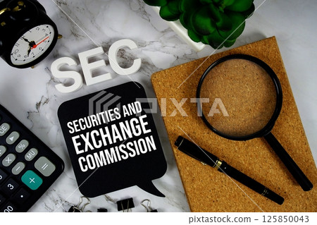 SEC -  Securities And Exchange Commission acronym with calculator, alarm clock and magnifying glass, business concept background 125850043