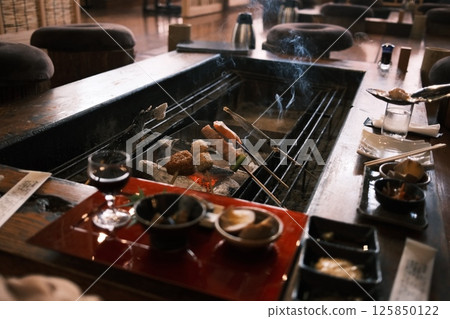 set of Robatayaki, a japanese cuisine, similar to barbecue, in which items of meat and seafood are cooked at varying speeds over hot charcoal. set of Robatayaki, a japanese cuisine, similar to barbecue, in which items of meat and seafood are cooked at varying speeds over hot charcoal. 125850122