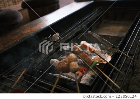 set of Robatayaki, a japanese cuisine, similar to barbecue, in which items of meat and seafood are cooked at varying speeds over hot charcoal. 125850124