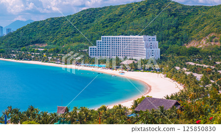 Luxury seaside hotel at sea with sandy beach in Hon Tre island in Nha Trang in Vietnam, aerial view. A resort in Asia Luxury seaside hotel at sea with sandy beach in Hon Tre island in Nha Trang in Vietnam, aerial view. A resort in Asia 125850830
