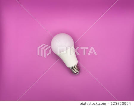 White diode light bulb on purple background without unnecessary objects top view 125850994