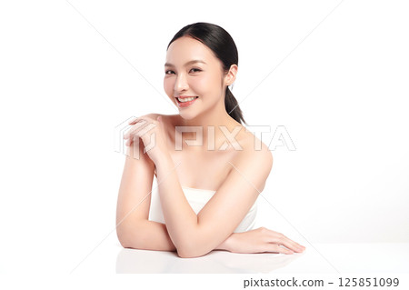 A beautiful young Asian woman with clean, fresh skin against a white background. Skincare, facial treatment, cosmetology, beauty, and spa. An elegant portrait of an Asian woman. 125851099