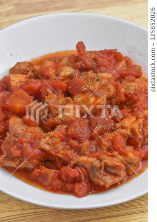 Chicken thigh stewed in tomato sauce Chicken thigh stewed in tomato sauce 125852026