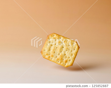 cracker levitating on beige background cracker levitating on beige background 125852887