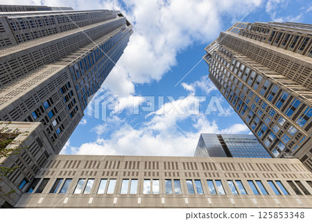 The exterior of the Tokyo Metropolitan Government Building in Shinjuku Ward, Tokyo. Blue sky and a huge building 125853348