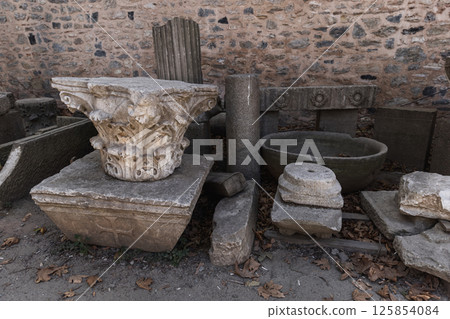 A collection of ancient stone artifacts, including columns and capitals A collection of ancient stone artifacts, including columns and capitals 125854084