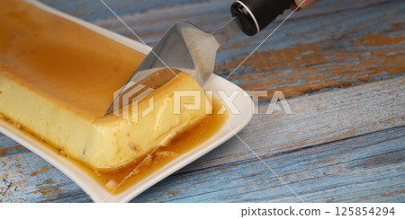 Cream caramel pudding with caramel sauce on a plate, Flan 125854294