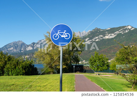 Bicycle path near mountain lake Como near Lecco, Italy 125854536