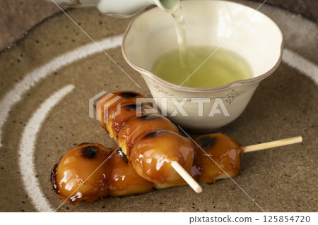 Mitarashi dango and tea in natural light 125854720