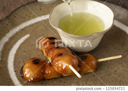 Mitarashi dango and tea in natural light Mitarashi dango and tea in natural light 125854721