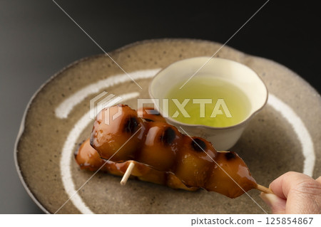 Mitarashi dumplings and tea Mitarashi dumplings and tea 125854867