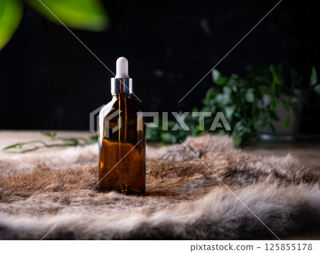 Dropper Pipette bottle for Cosmetic serum, essential oil, Herbal Aroma Theraphy oil set on dark background. 125855178