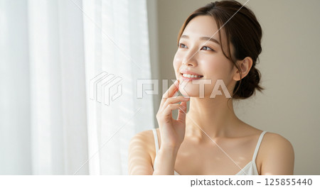 Young woman with beautiful hair blowing in the wind Young woman with beautiful hair blowing in the wind 125855440