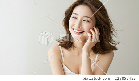 Young woman with beautiful hair blowing in the wind 125855452