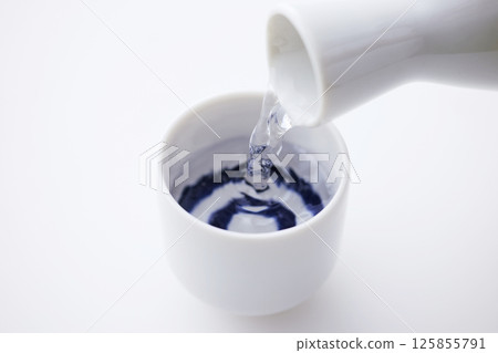 Sake poured into Ochoko Sake poured into Ochoko 125855791