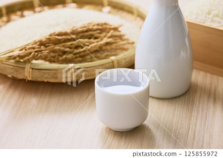 Sake poured into Ochoko 125855972