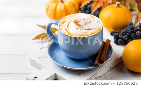 Pumpkin spice latte. Blue coffee cup with creamy foam, Fall hot drinks, cafe and bar concept Pumpkin spice latte. Blue coffee cup with creamy foam, Fall hot drinks, cafe and bar concept 125856628