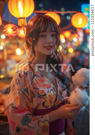 A young woman in a yukata A young woman in a yukata 125856657