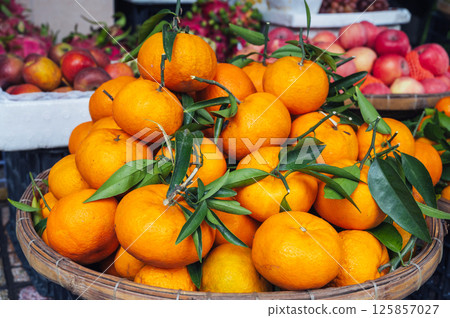 pile of fresh ripe sweet tangerines on the counter at market in Asia close-up 125857027