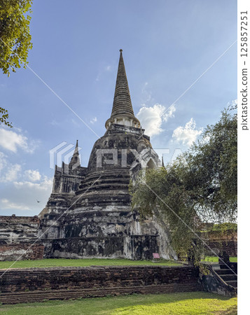 Ancient beautiful Wat Chaiwatthanaram Ayutthaya historic temple, brick towers glowing in the sunlight. Spiritual heritage, culture and architectural features for a sacred landmark. 125857251