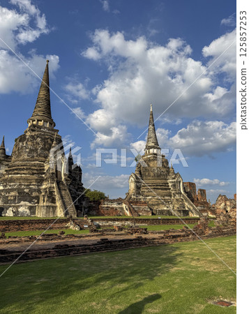 Majestic spiritual Wat Chaiwatthanaram Ayutthaya historic temple, ancient beautiful brick towers glowing under a golden sunset. Spiritual heritage, culture and architectural features. 125857253