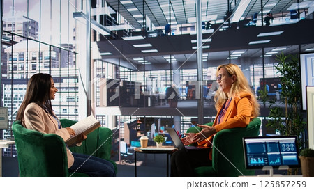 Female business leader in a professional office strategizing for development success, discussing with the main investor. Self accomplished women driving innovation and gender equality. Camera B. Female business leader in a professional office strategizing for development success, discussing with the main investor. Self accomplished women driving innovation and gender equality. Camera B. 125857259