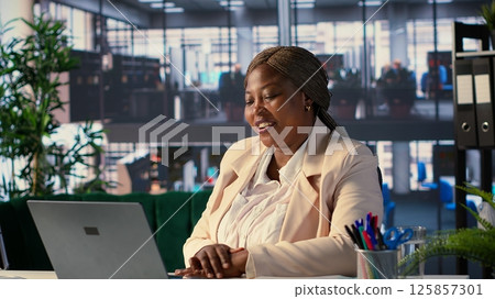 Woman director attending videocall conference with the advisory board, planning investment during decision making meeting online. Shareholders with executive power and CEO discuss target. Camera A. Woman director attending videocall conference with the advisory board, planning investment during decision making meeting online. Shareholders with executive power and CEO discuss target. Camera A. 125857301
