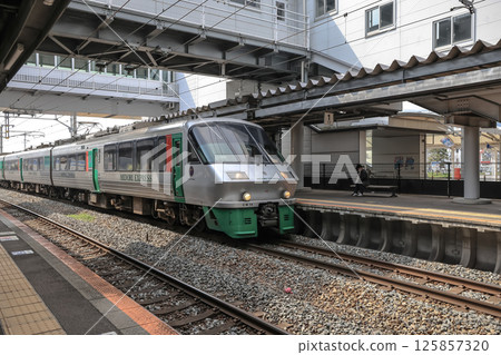 March 26 2025 Modern Train at Station Platform Beneath Artistic Overpass Structure, Japan March 26 2025 Modern Train at Station Platform Beneath Artistic Overpass Structure, Japan 125857320
