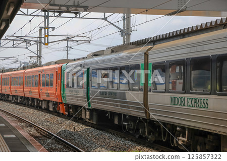 March 26 2025 Modern Train at Station Platform Beneath Artistic Overpass Structure, Japan March 26 2025 Modern Train at Station Platform Beneath Artistic Overpass Structure, Japan 125857322