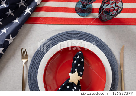American table setting for USA Independence Day. Festive dinner with empty plate and decoration in USA national flag colors. Happy Memorial Day. View from above American table setting for USA Independence Day. Festive dinner with empty plate and decoration in USA national flag colors. Happy Memorial Day. View from above 125857377