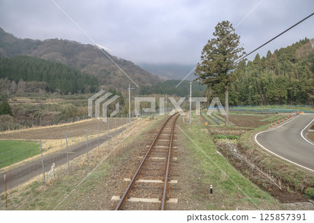 March 26 2025 Scenic Railway Track Passing Through Lush Countryside and Forested, Japan March 26 2025 Scenic Railway Track Passing Through Lush Countryside and Forested, Japan 125857391