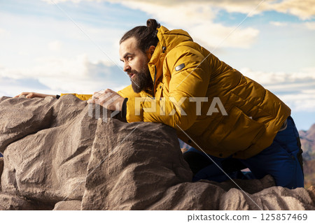 Inexperienced tired trekker loses his footing in extreme conditions, struggling to keep his balance as he tumbles. Remote wilderness offers beauty but also grave risks, reckless. Inexperienced tired trekker loses his footing in extreme conditions, struggling to keep his balance as he tumbles. Remote wilderness offers beauty but also grave risks, reckless. 125857469