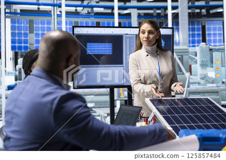 Businesswoman in industrial plant presenting solar cells materials to investors, securing necessary capital funding. Factory manager showing assets to shareholders during presentation Businesswoman in industrial plant presenting solar cells materials to investors, securing necessary capital funding. Factory manager showing assets to shareholders during presentation 125857484