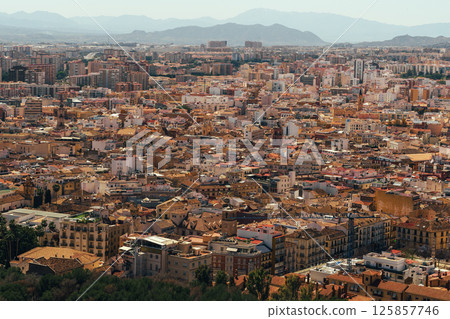 Urban sprawl under sunny skies: a sprawling cityscape nestled in the valley. Urban sprawl under sunny skies: a sprawling cityscape nestled in the valley. 125857746