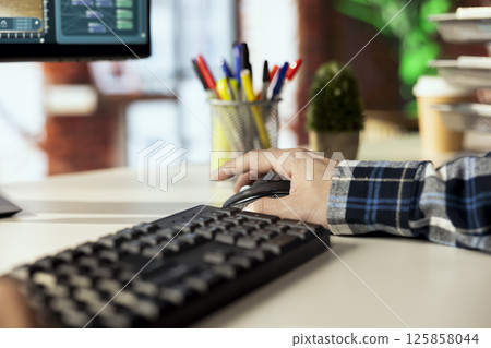 Man at home playing simulation videogame on PC, acting as interior designer remodeling room. Gamer having fun making home floor plans on immersive computer game, close up shot 125858044