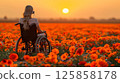 young woman sits in a wheelchair wearing headphones and listening to music. 125858178