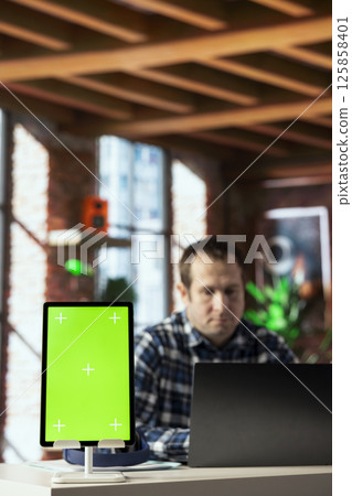 Close up of isolated screen tablet used by worker in home office analyzing data charts, identifying trends. Freelancer using chroma key device, compiling analytical reports, processing data 125858401