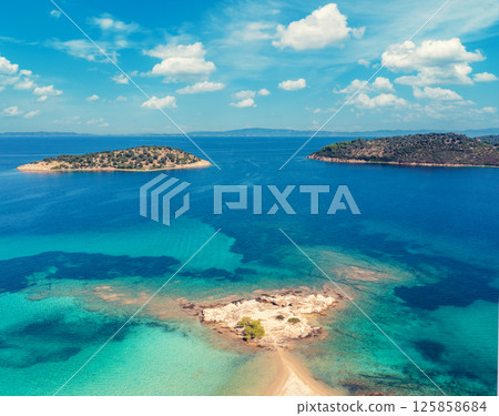 Seascape on a sunny day, view from above with beautiful bay. Texture of a sandy Lagonisi beach in Greece Europe. Seascape on a sunny day, view from above with beautiful bay. Texture of a sandy Lagonisi beach in Greece Europe. 125858684