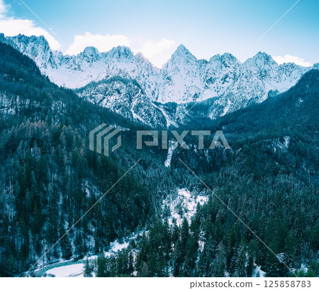 The tops of the mountains are covered with snow. View of the Alps in Gozd Martuljek, at sunrise. Triglav national park. Gozd Martuljek, Slovenia, Europe The tops of the mountains are covered with snow. View of the Alps in Gozd Martuljek, at sunrise. Triglav national park. Gozd Martuljek, Slovenia, Europe 125858783
