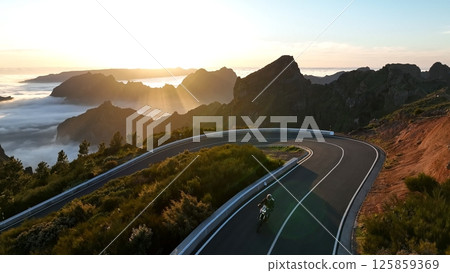 Motorcycle Rider Driving in High Mountain Landscape, Madeira Island , Portugal. Motorcycle Rider Driving in High Mountain Landscape, Madeira Island , Portugal. 125859369