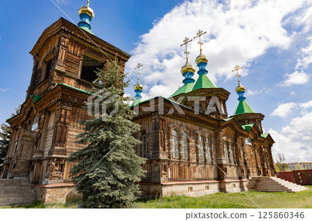 Holy Trinity Cathedral in Karakol city, Kyrgyzstan. Wooden church, architecture. Kyrgyzstan Diocese of the Russian Orthodox Church Holy Trinity Cathedral in Karakol city, Kyrgyzstan. Wooden church, architecture. Kyrgyzstan Diocese of the Russian Orthodox Church 125860346