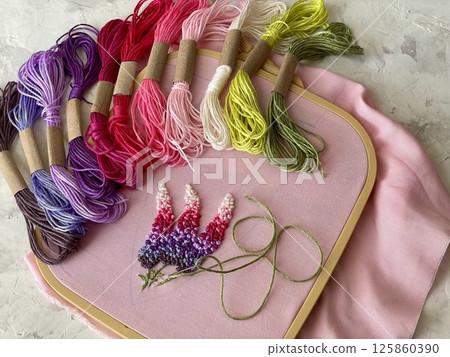 embroidery of flowers in French knot technic, canvas, threads mouline and needle embroidery of flowers in French knot technic, canvas, threads mouline and needle 125860390