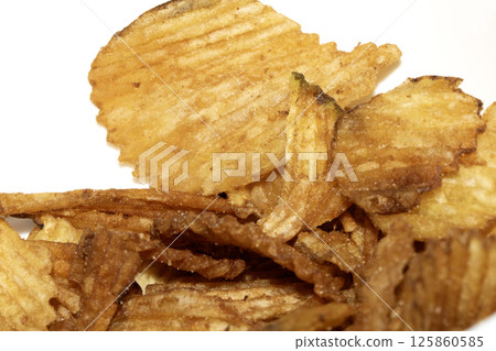 Close up of fresh crinkle cut seasoned crisps snack Close up of fresh crinkle cut seasoned crisps snack 125860585